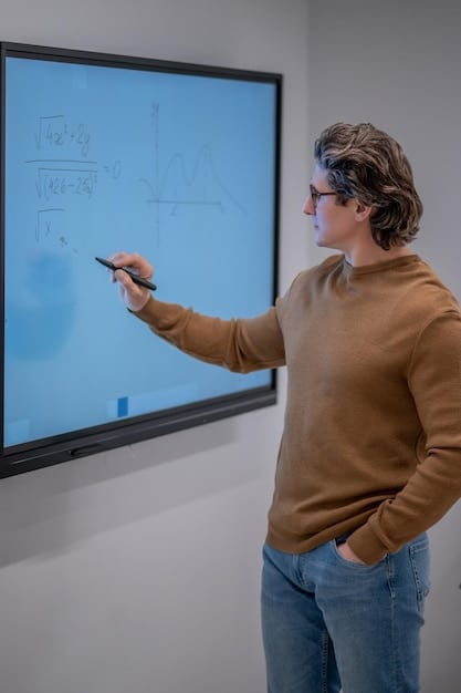 A teacher using a digital whiteboard to teach a mathematics lesson to a class of middle school students. The classroom is equipped with modern technology, illustrating how the Education Reform Act aims to integrate innovative teaching methods and resources.