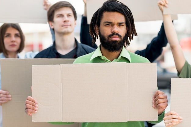 An eye-level shot of a group of protestors holding signs advocating for different immigration policies. The signs include phrases like 