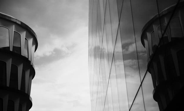 A split image contrasting a well-lit, transparent glass building representing open government policies with a shadowy, opaque building symbolizing corruption and lack of transparency.