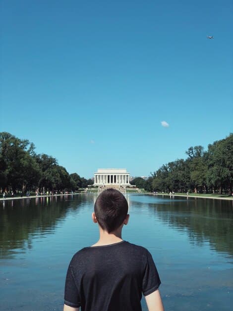 An airplane taking off against a backdrop of the U.S. Capitol Building, symbolizing the intersection of travel, politics, and ethical scrutiny.